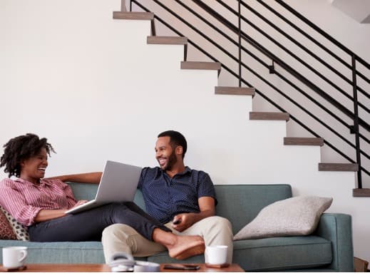 Couple at Home with Laptop on Couch