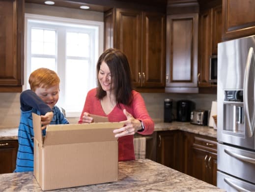 Mother and son opening a package at home